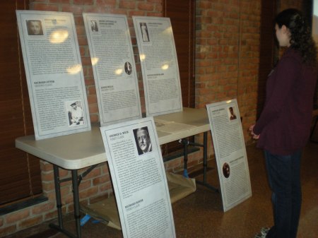 Members of the East Cuyahoga County Genealogical Society took time to read the stories of some of the Ohio-bound passengers displayed on poster-size panels.